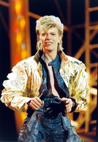 David Bowie performing on stage.