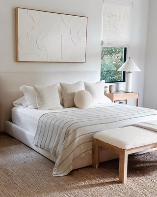 White bedroom with light wood accents