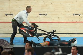 Britain's Neah Evans suffers a crash in the women's track cycling omnium scratch race of the Paris 2024 Olympic Games at the Saint-Quentin-en-Yvelines National Velodrome in Montigny-le-Bretonneux, south-west of Paris, on August 11, 2024. (Photo by Emmanuel DUNAND / AFP)