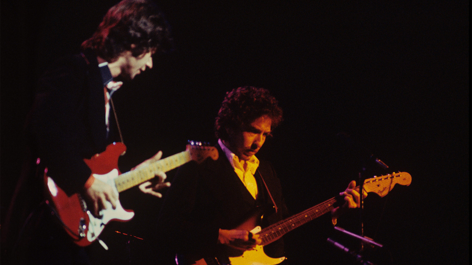 Robbie Robertson of The Band performs on stage with Bob Dylan at Madison Square Garden on 29th January 1974 in New York. They both play Fender Stratocaster guitars.