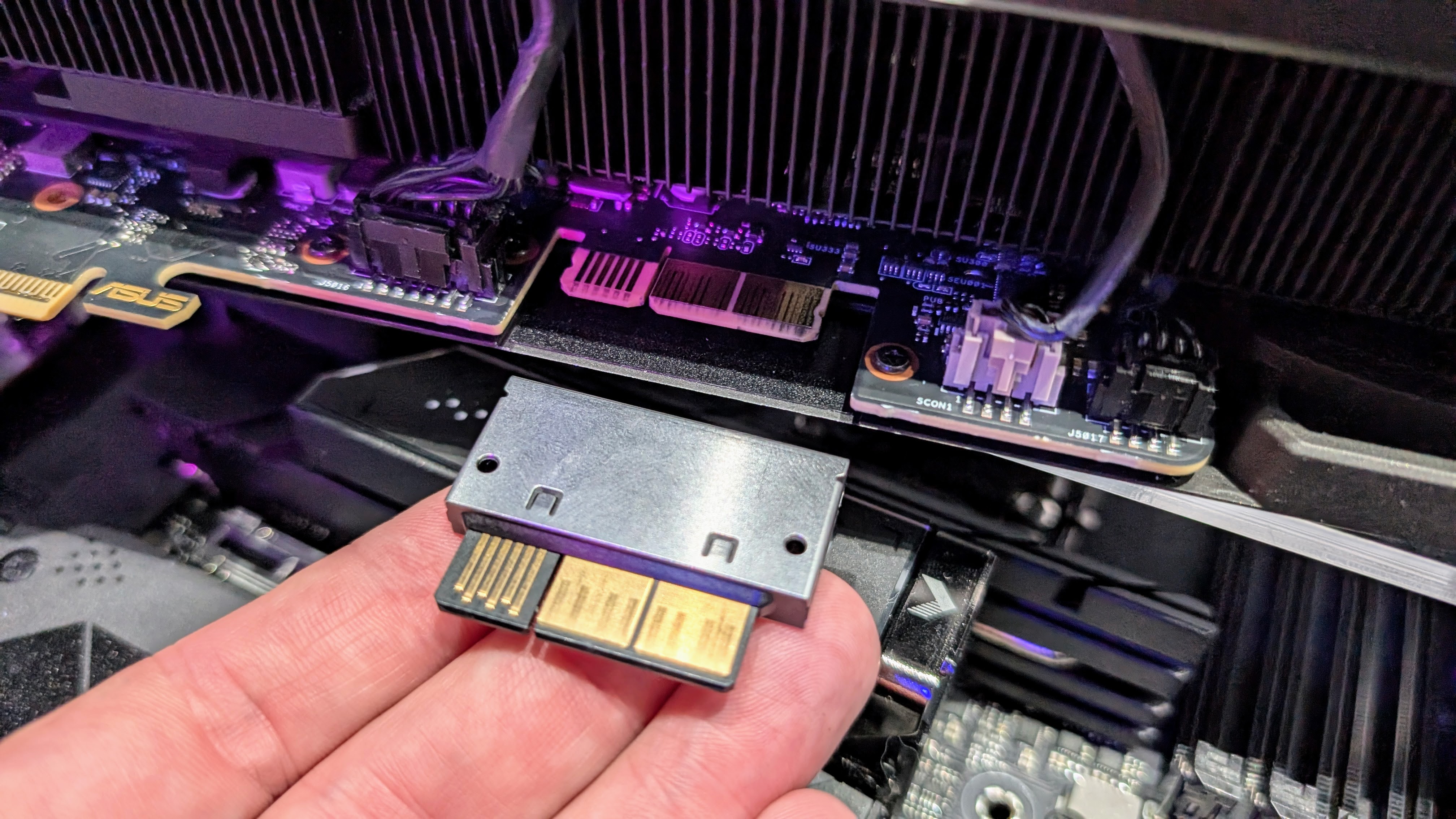 Asus hidden connector concept connector held in a hand at Computex 2025