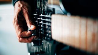 Closeup of a man's hand playing electric guitar