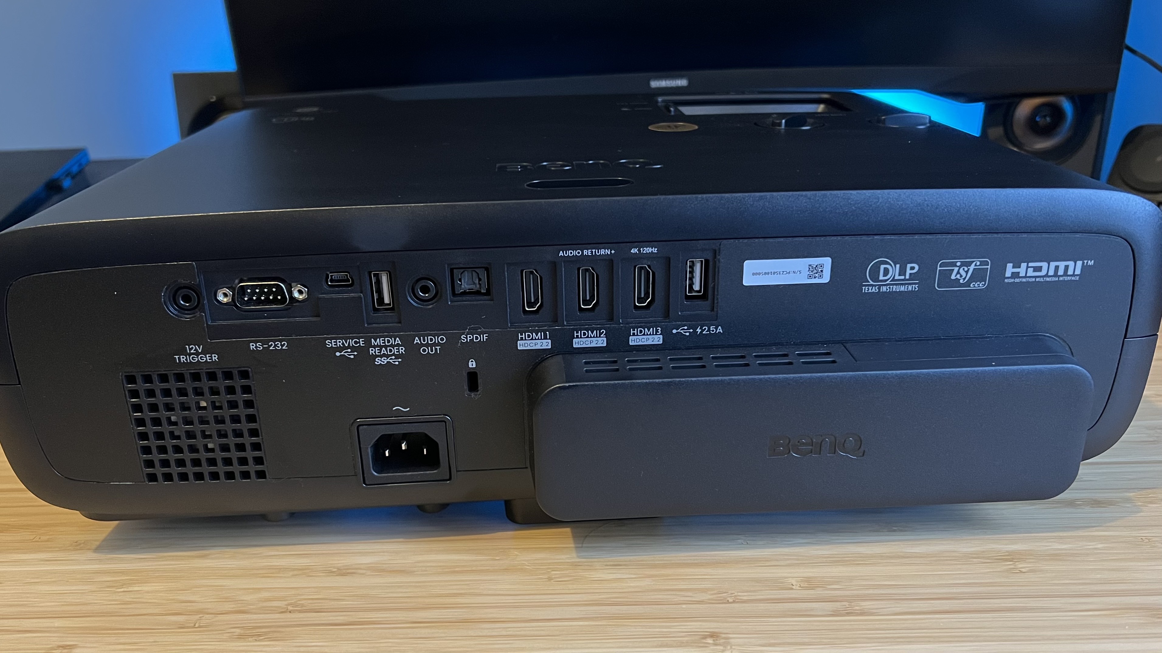 Rear I/O panel of BenQ W4100i gaming projector with ports visible and extended dongle housing