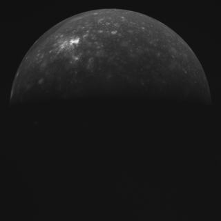 a dimly lit grey orb of a planet.