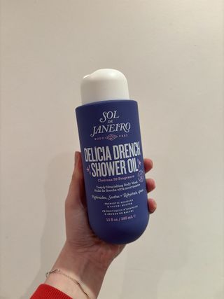 Mica Ricketts holding Sol de Janeiro Delícia Drench Shower Oil