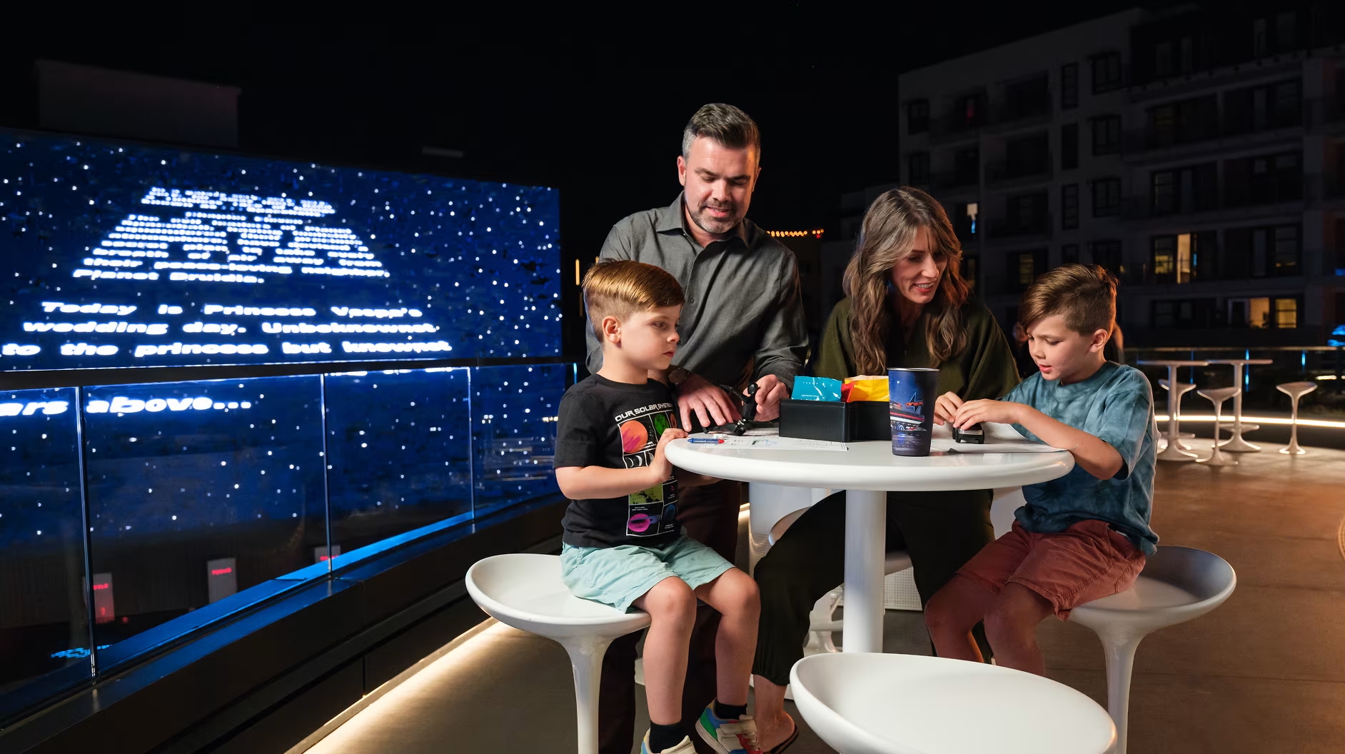 A smiling family in the Tesla diner
