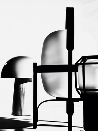 Black and white photograph of three table lamps by Marset, Fritz Hansen and Santa & Cole