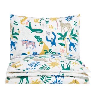 A childrens bedding set with a green, yellow, and blue jungle print