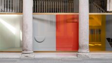 Showroom facade featuring abstract shapes and shadows made using colourful textiles and coloured film