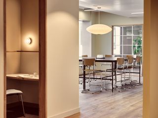 Co working space interior in london with workstations and private booths