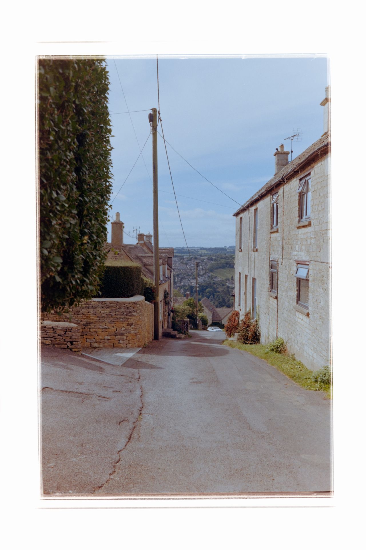 Street lined with old stone houses with a telegraph pole