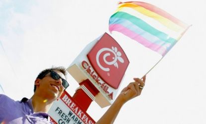 A protester waves a gay pride flag outside a Chick-Fil-A restaurant during a nationwide "kiss-in" on Aug. 13.