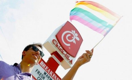 A protester waves a gay pride flag outside a Chick-Fil-A restaurant during a nationwide &amp;quot;kiss-in&amp;quot; on Aug. 13.