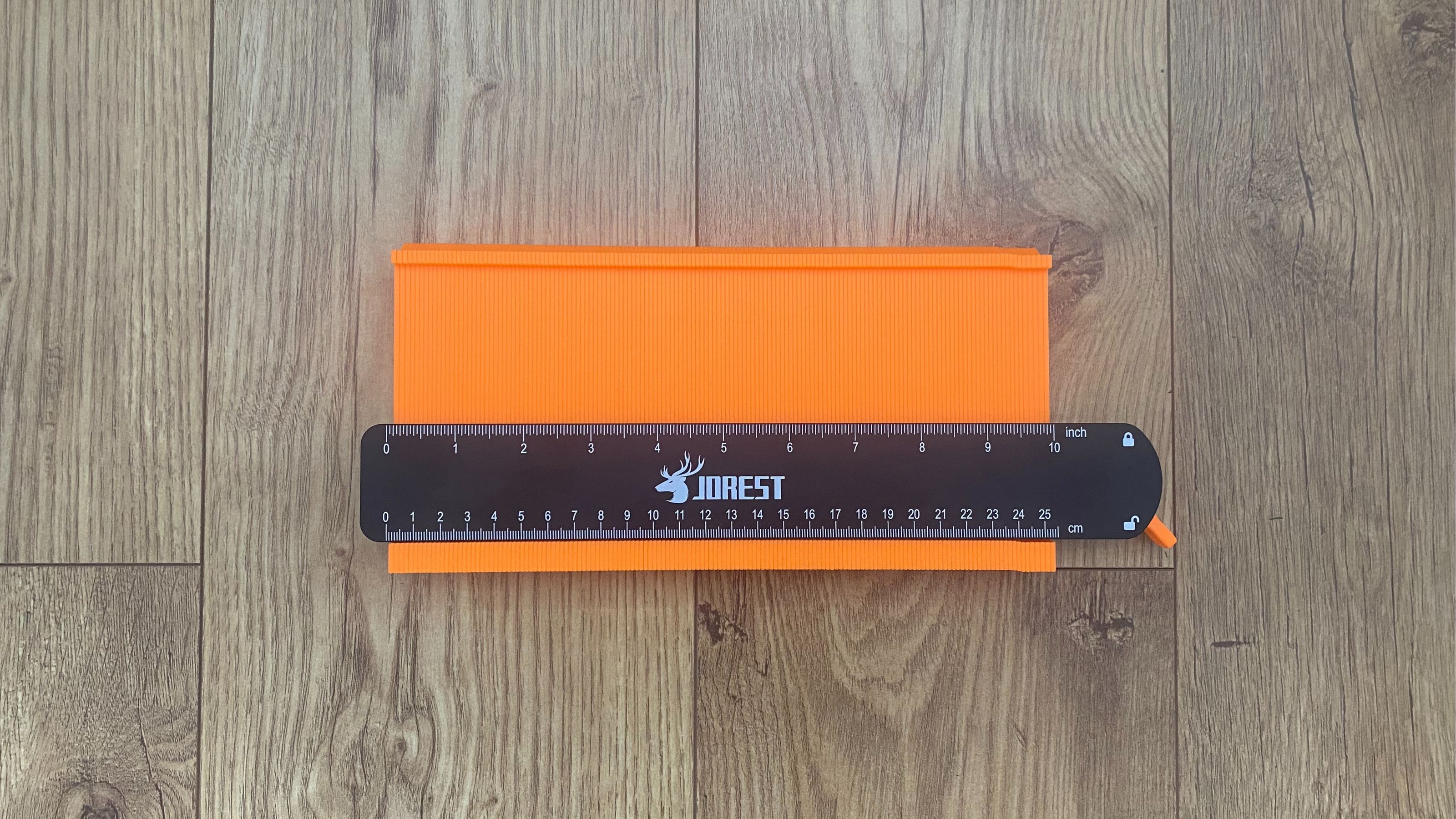 10 inch contour gauge laying on oak effect LVT flooring