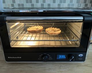 Toasting a sliced bagel in the KitchenAid Digital Countertop Oven with air fryer