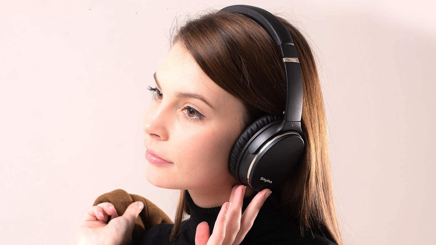 Woman wearing Srhythm NC35 headphones.