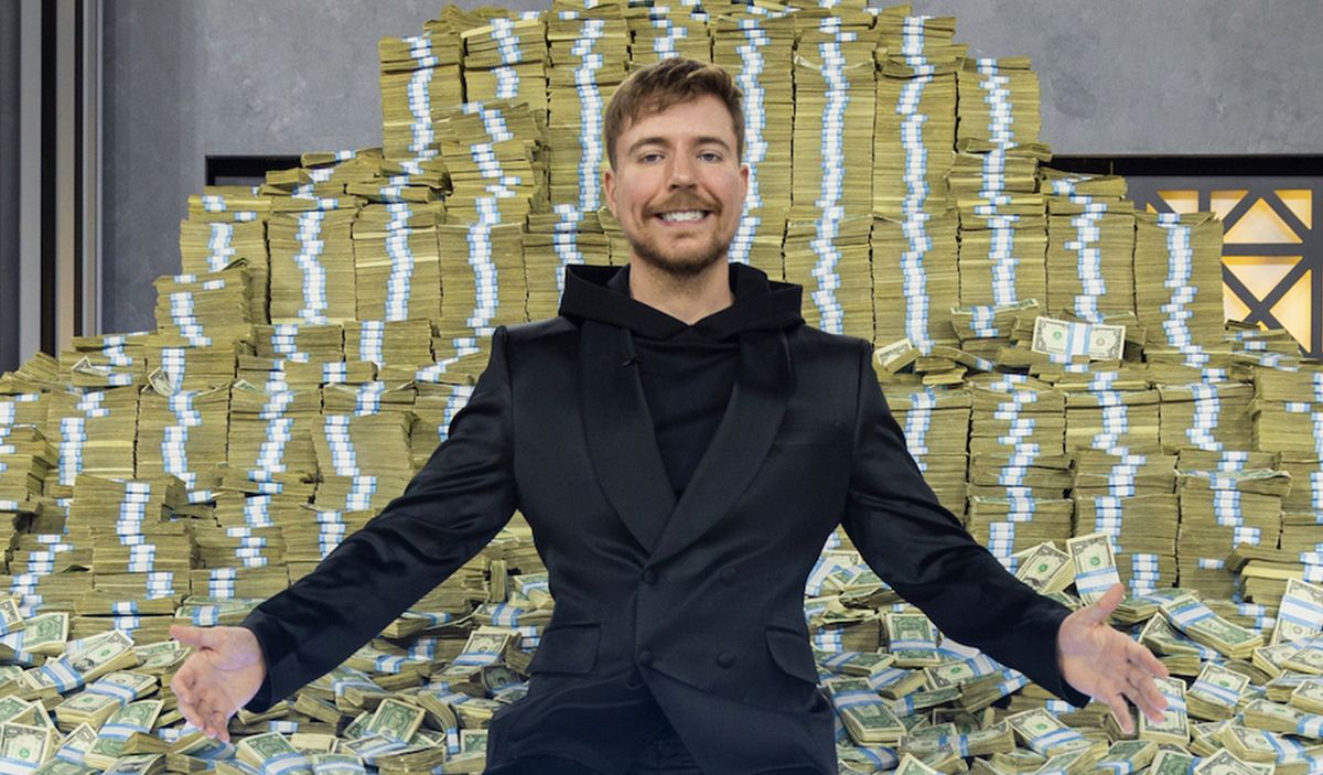 MrBeast smiling in front of a pile of cash