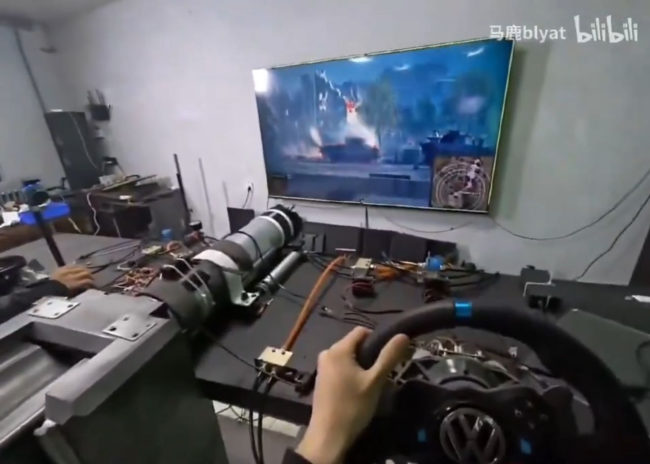 Tank driver using Volkswagen steering wheel to steer tank