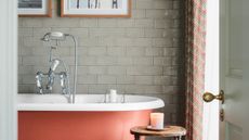 Bathroom wall tiles with orange bath