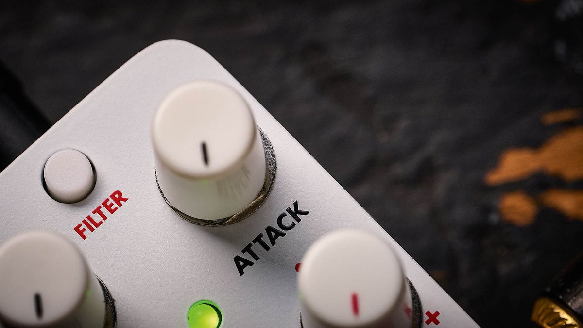Electro-Harmonix Pico Swello: the compact mini-pedal is finished in white and has black and white text, four knobs, and is photographed against a distressed wood floor.