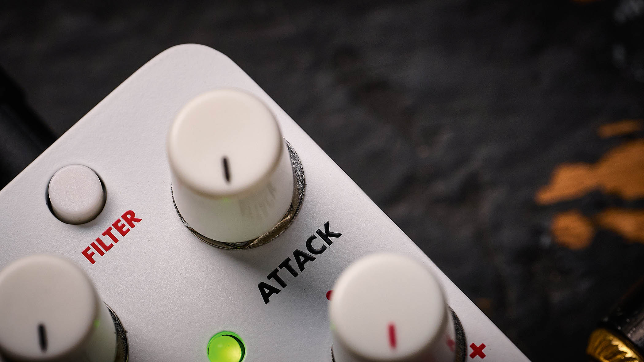 Electro-Harmonix Pico Swello: the compact mini-pedal is finished in white and has black and white text, four knobs, and is photographed against a distressed wood floor.