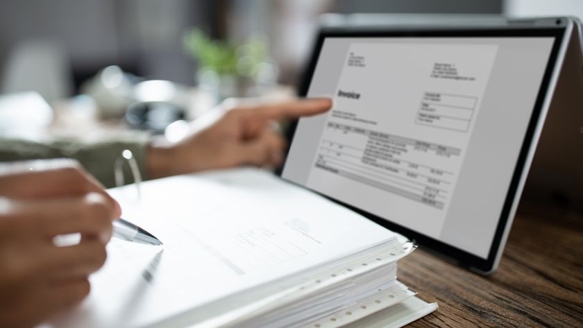 Someone at a laptop processing an Invoice.