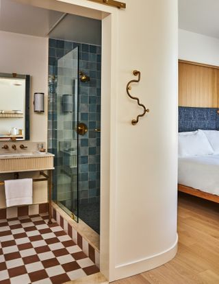 A curve wall leads from the bedroom to the bathroom in the deluxe king room at the Alsace hotel
