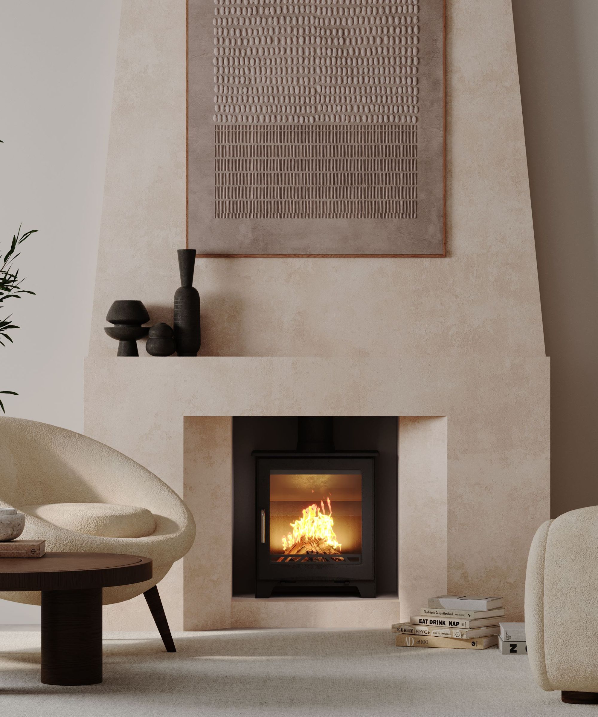 A contemporary living space with a log burner inset into a large textured stone fireplace. Neutral-toned curved armchairs and stacks of books surround the hearth, while a large patterned artwork hangs above.