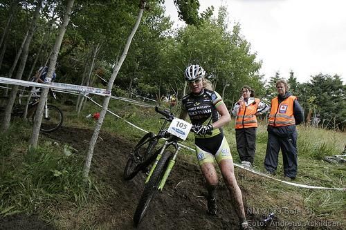 Gunn-Rita Dahle Flesjaa runs with her bike.