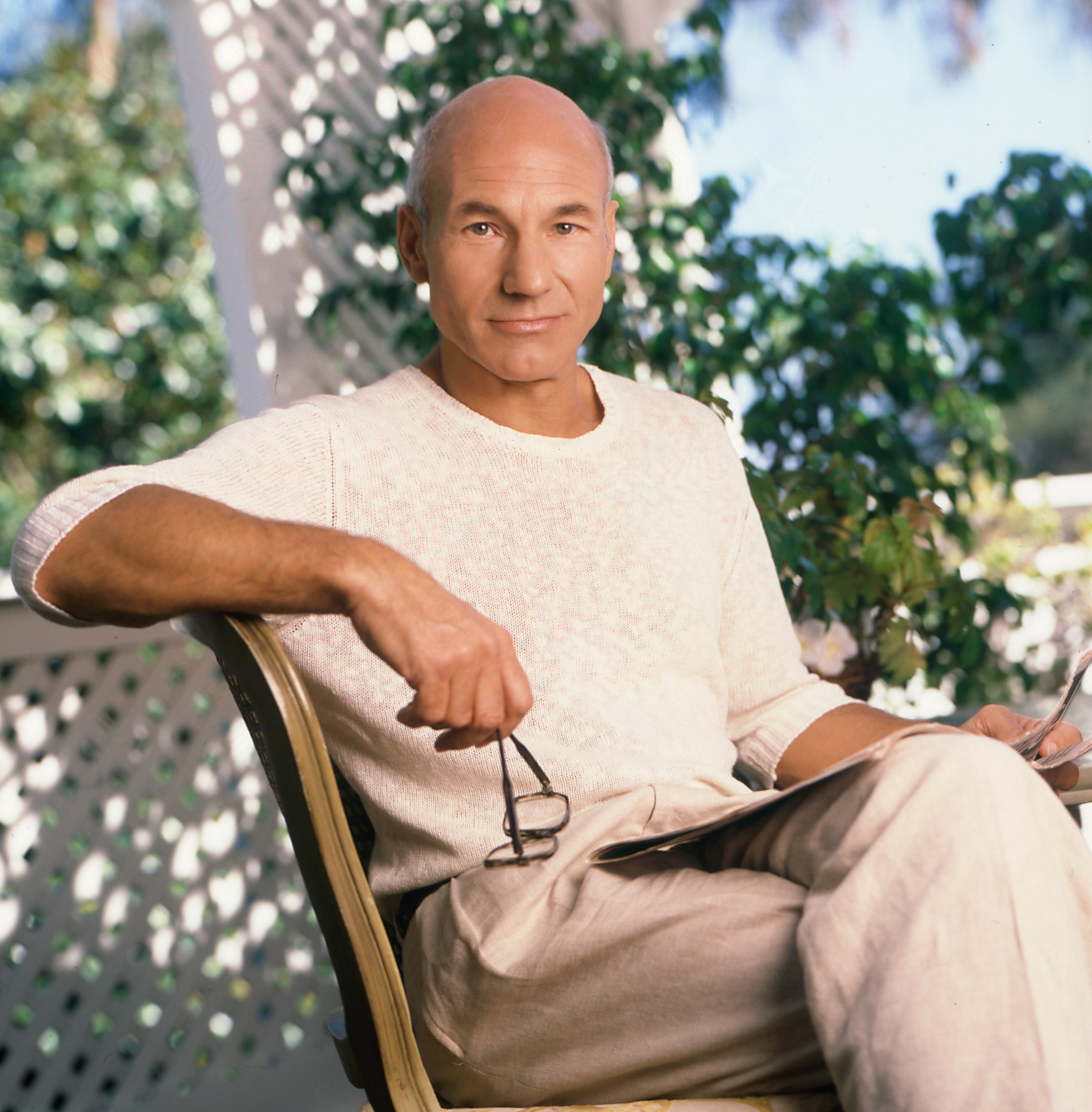 A photo of Patrick Stewart looking relaxed and reading