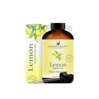 A lemon essential oil bottle with a yellow box