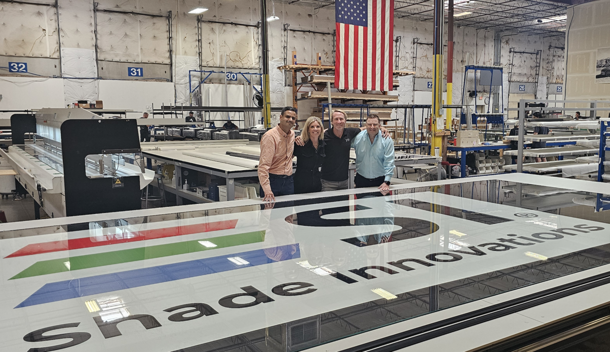 Screen Innovations new hires posing together in the warehouse.