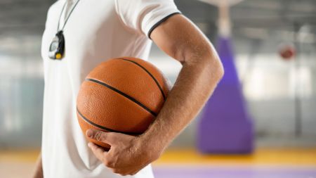 Close up of basketball coach holding ball