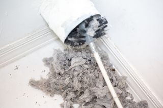 removing lint with a vent brush