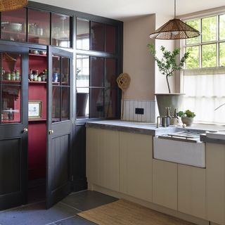 Shaker kitchen with glass door pantry with red interior.