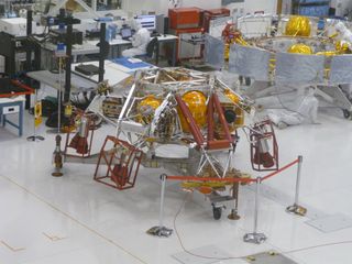 A zoomed-in view shows the rocket-powered sky crane (foreground) that will lower NASA's Curiosity rover to the Martian surface. In the background, technicians work on the cruise stage that will get Curiosity to the Red Planet. This photo was taken in May 2011 at NASA's Jet Propulsion Lab in Pasadena, Calif.