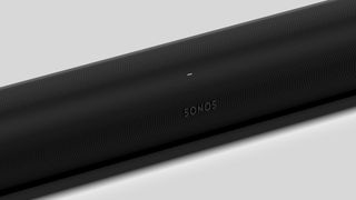 A close-up of a black Sonos Arc, showing the 'Sonos' logo