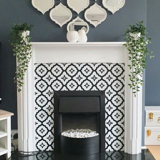 blue wall room with fireplace having white with black printed wall