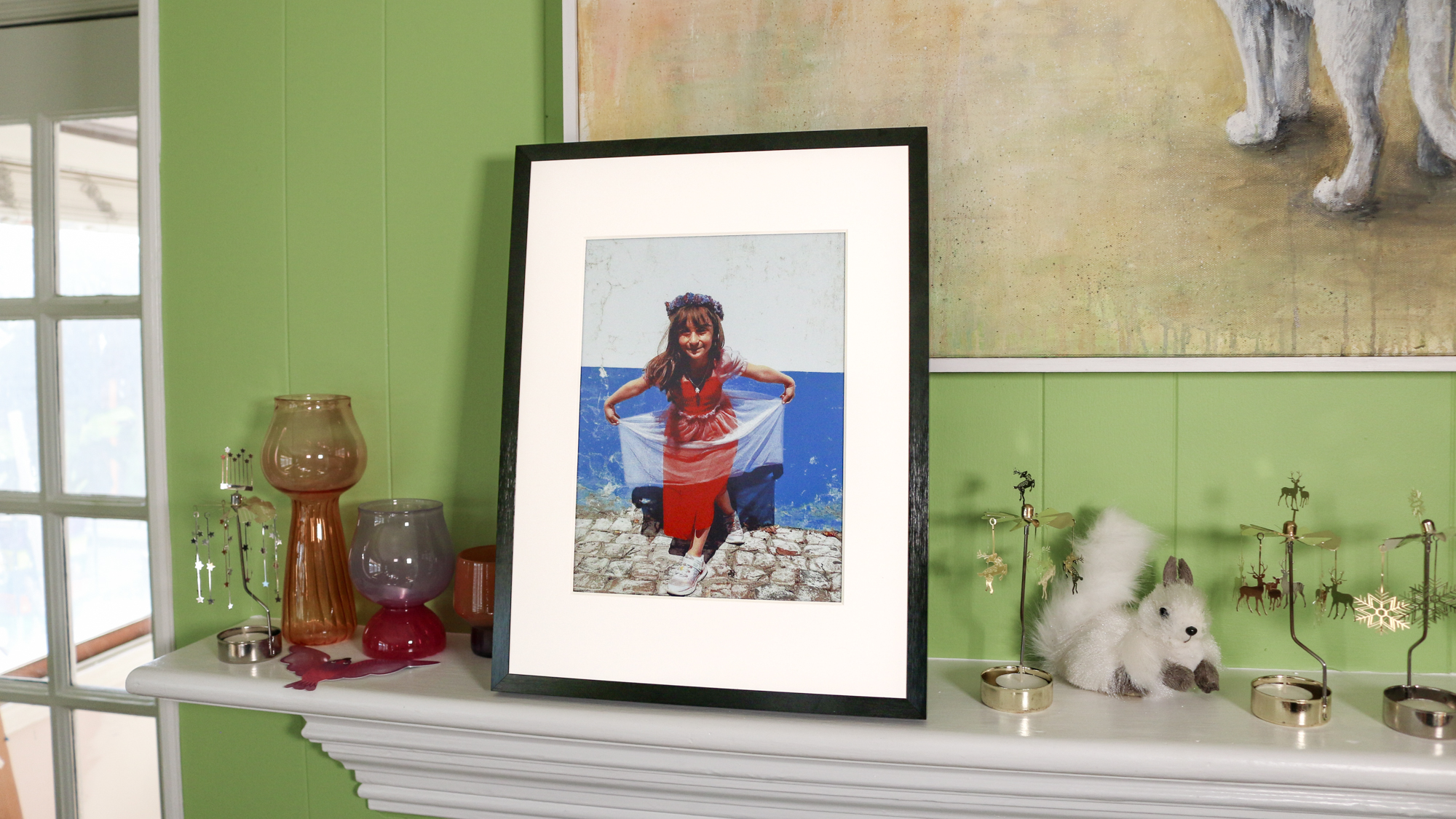 A Switchbot photo frame on a mantlepiece