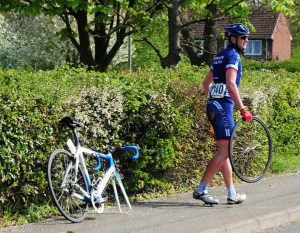 Peter Johnson goes to a wheel after a crash in the early stages of the race.