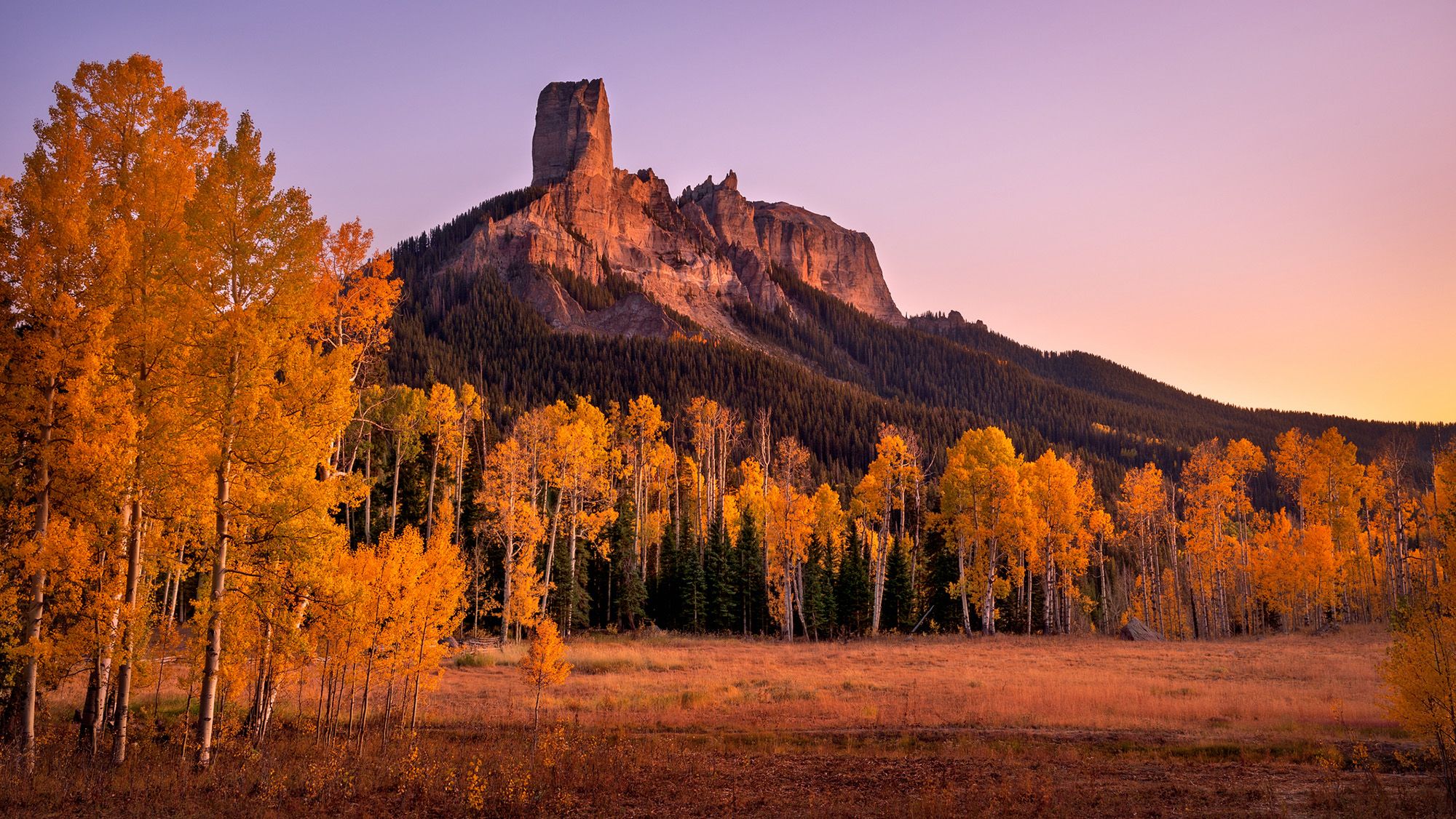 A tall rocky peak on a hill.
