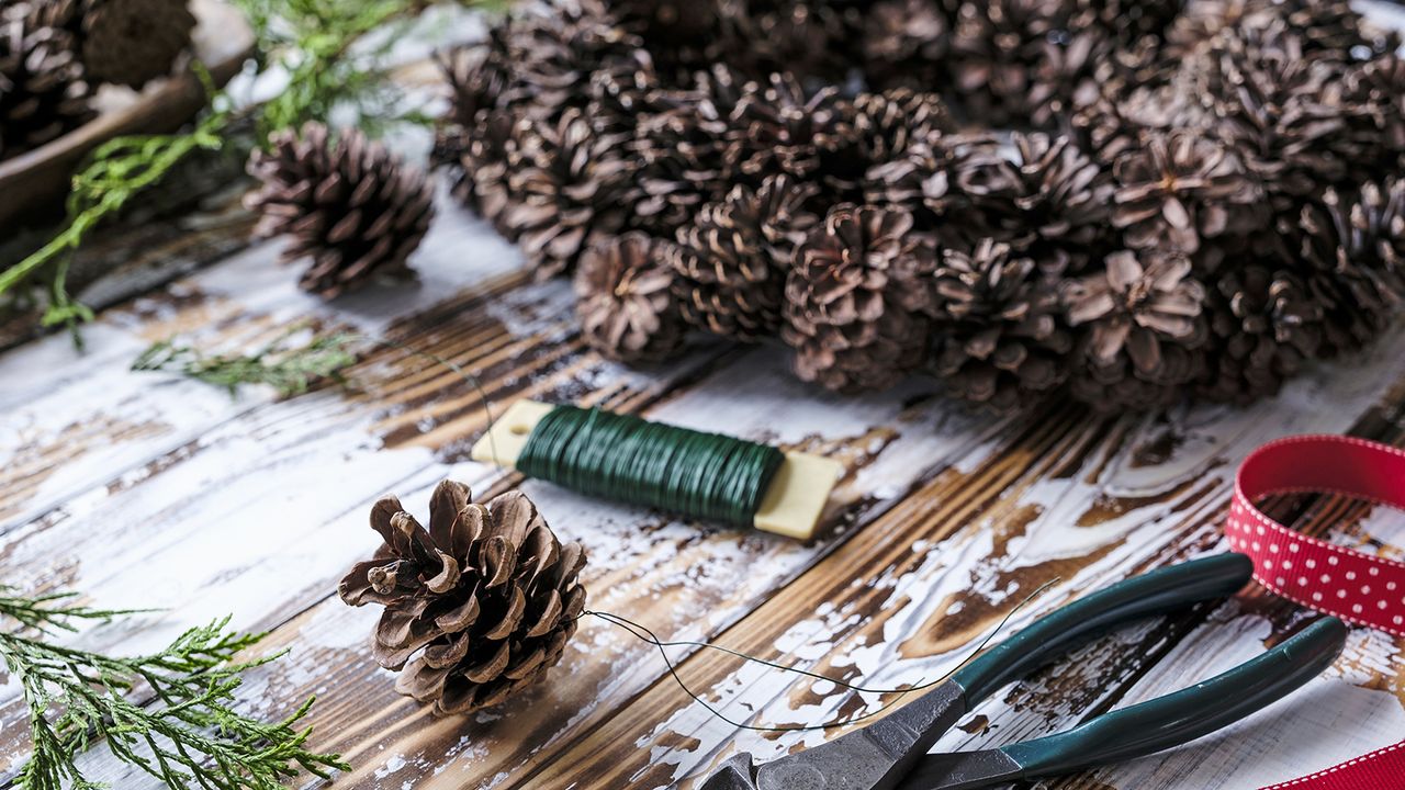 Pinecones being crafted into wreath