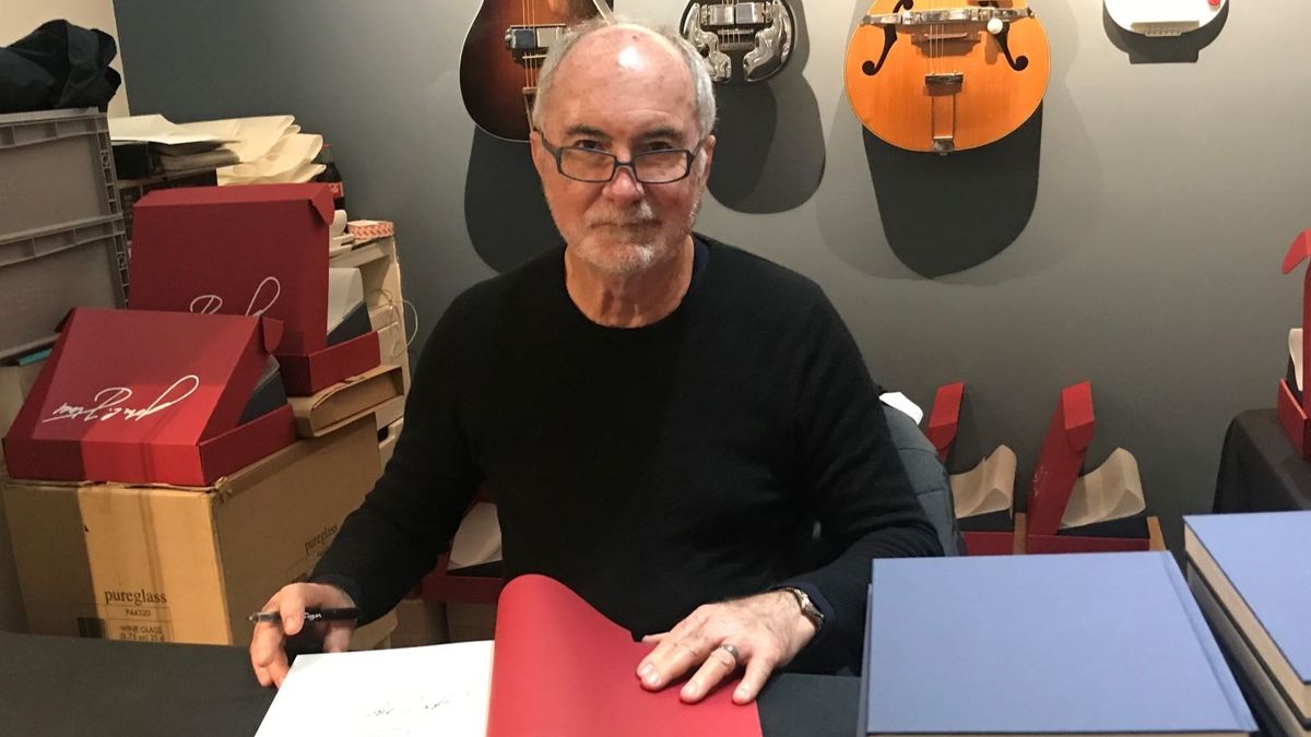 John Hall signing &#039;Rickenbacker Guitars: Out of the Frying Pan Into the Fireglo&#039; copy at Shapero Rare Books&#039; Rickenbacker exhibition in 2022