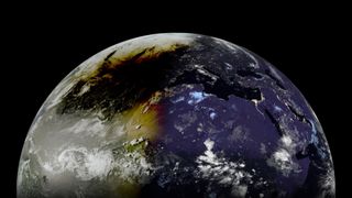 A picture of Earth captured from an orbiting spacecraft. Its right side is shadowed, and the moon's dark shadow can be seen darkening the daylit side during an eclipse.