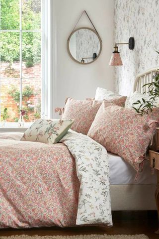Laura Ashley pink floral bedding set from the side with plant and window