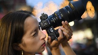 Nikon Z7ii with Nikon Z 24-70mm f/2.8 lens being used by female photographer