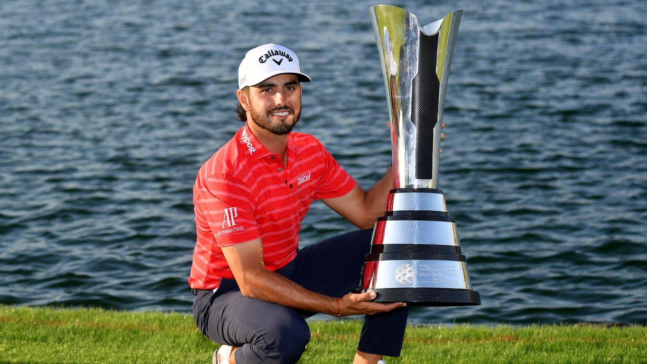 Abraham Ancer poses for a photo with the Saudi International trophy