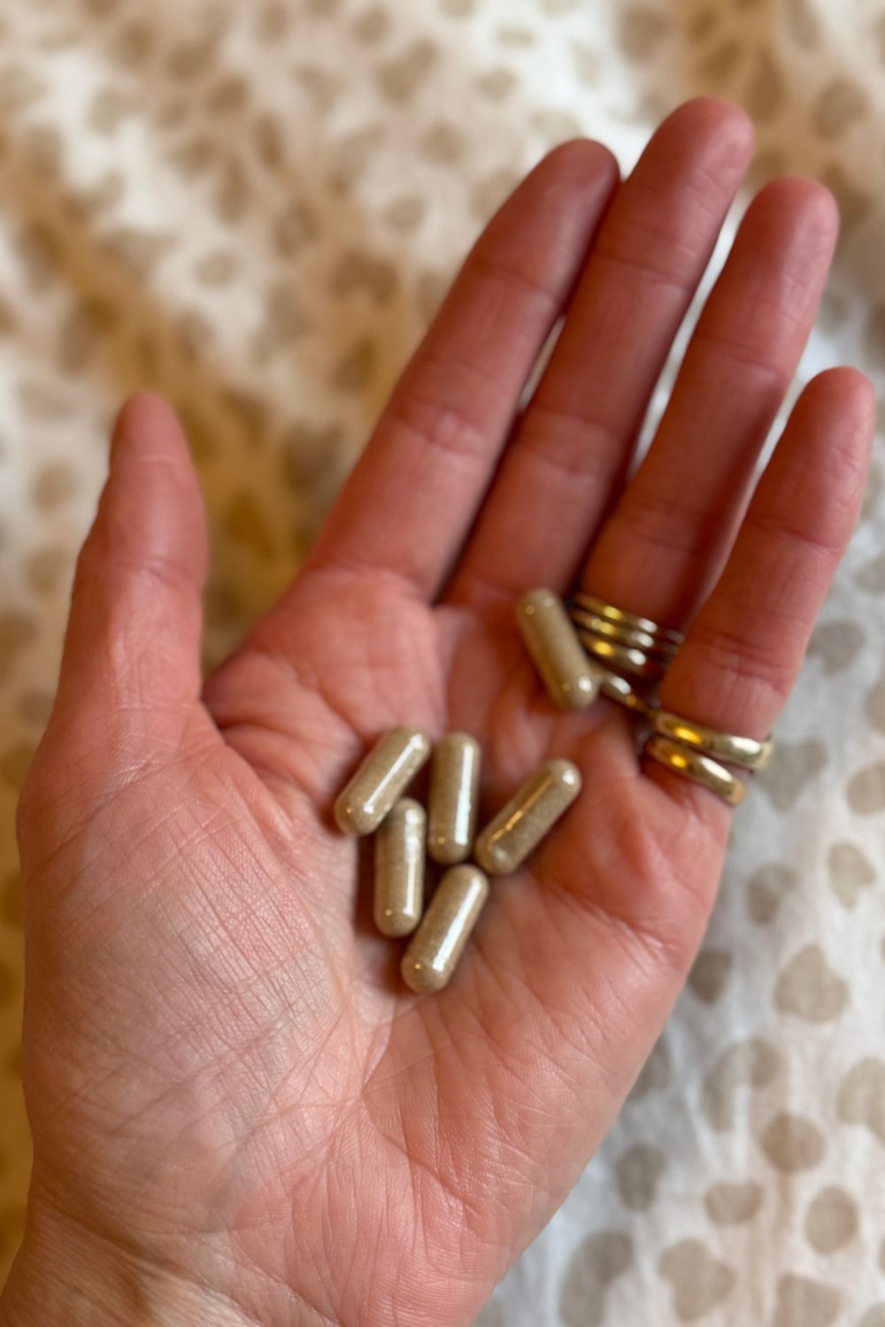 Katie Thomas holding out her palm to show the Diome Rested pills