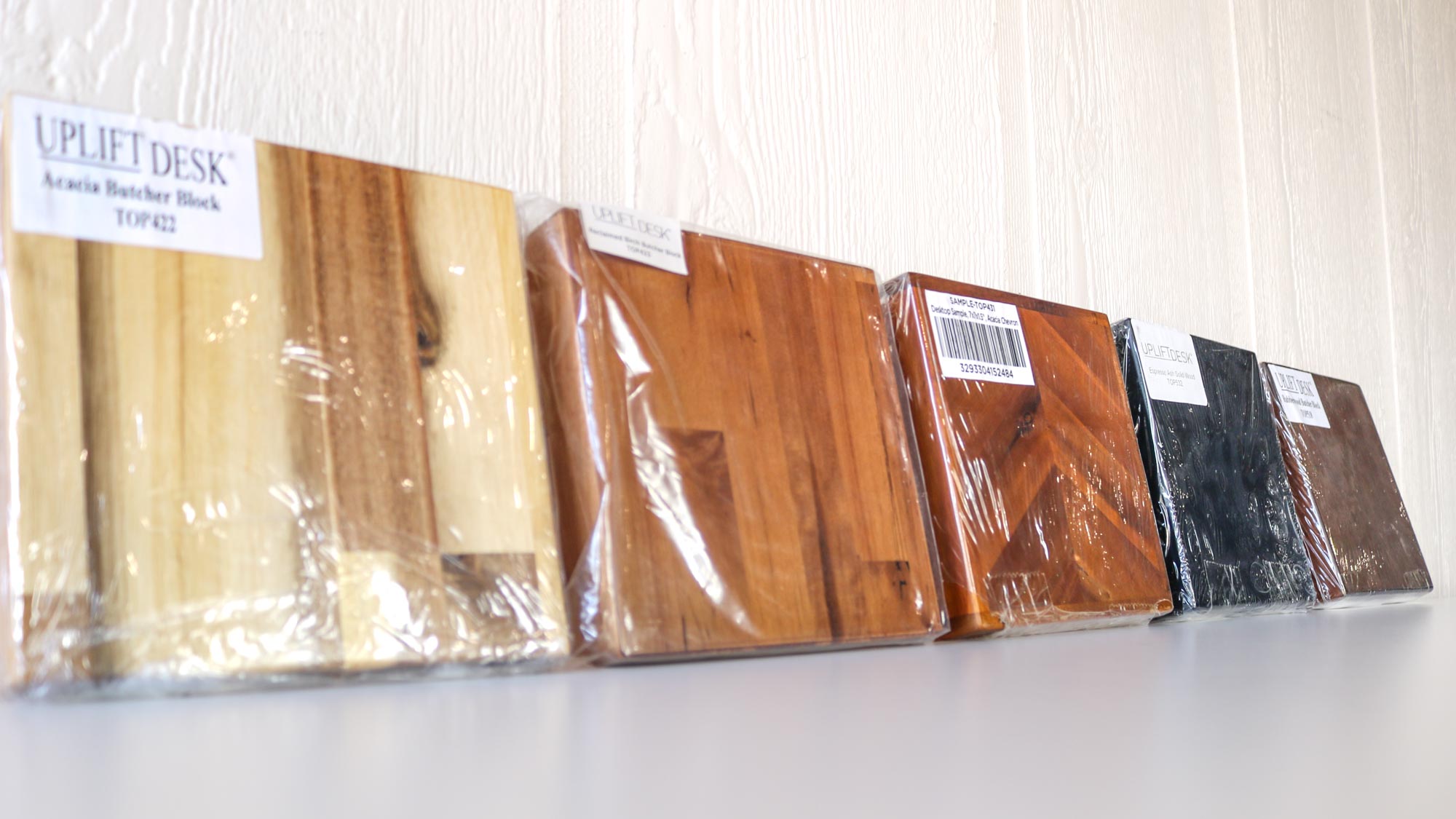 Several wooden desktop samples on a table