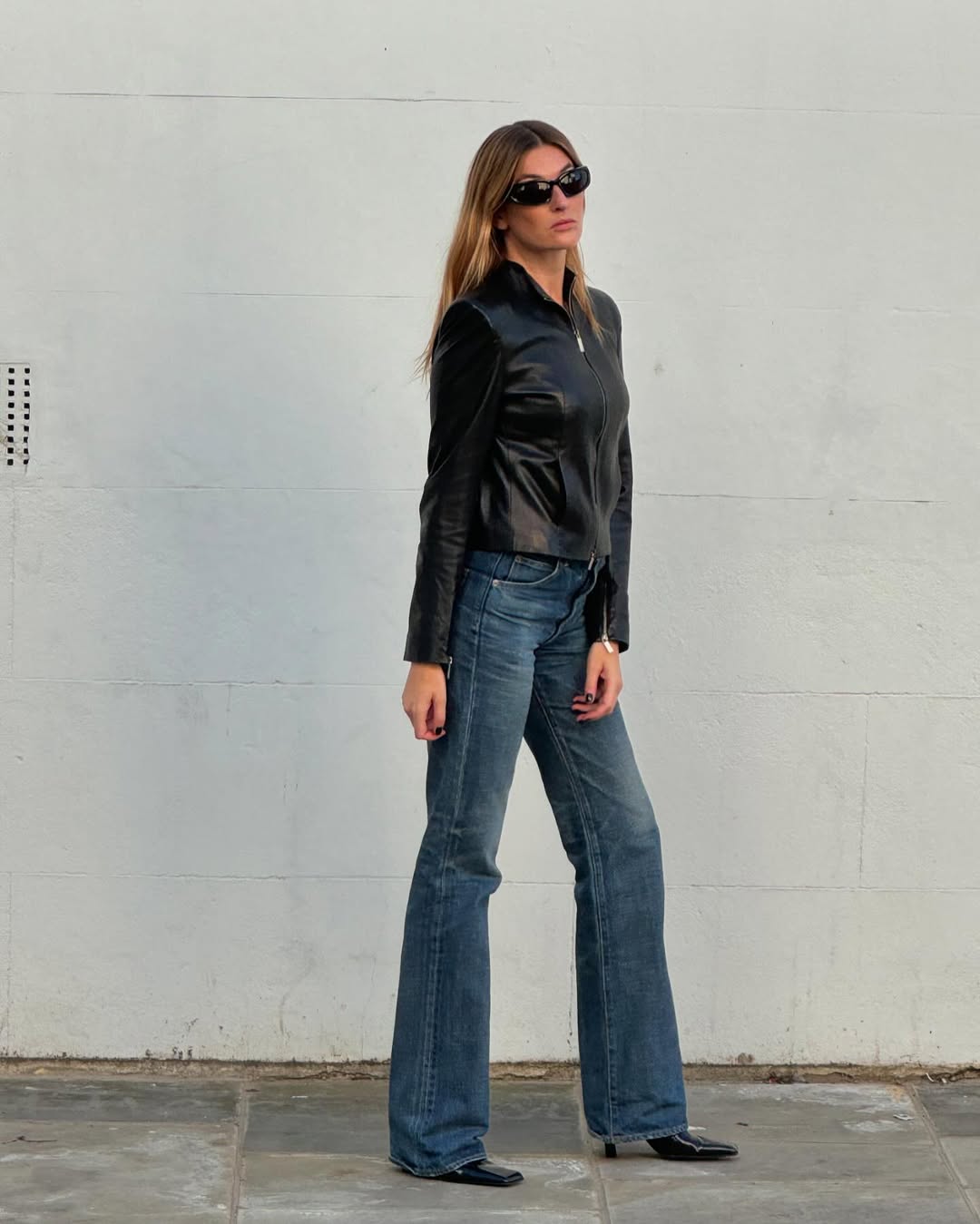 Camille Charriere wearing bootcut jeans with a leather jacket